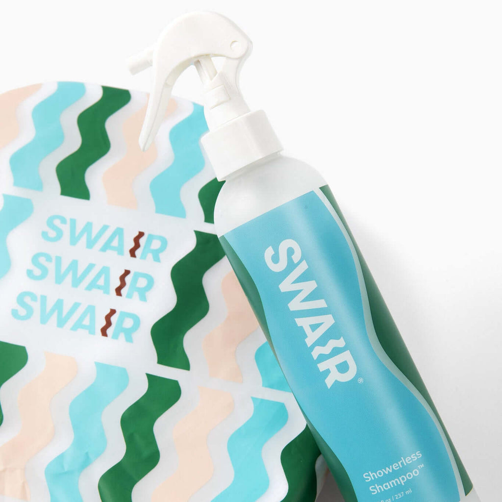 Close up image of Showerless Shampoo and SWAIR Shower Cap on white background