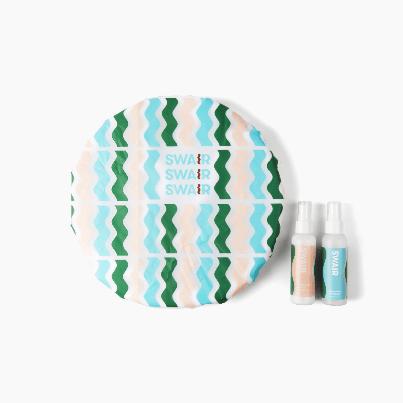 Mini Showerless Shampoo, Mini SweatShield and SWAIR Shower Cap on white background